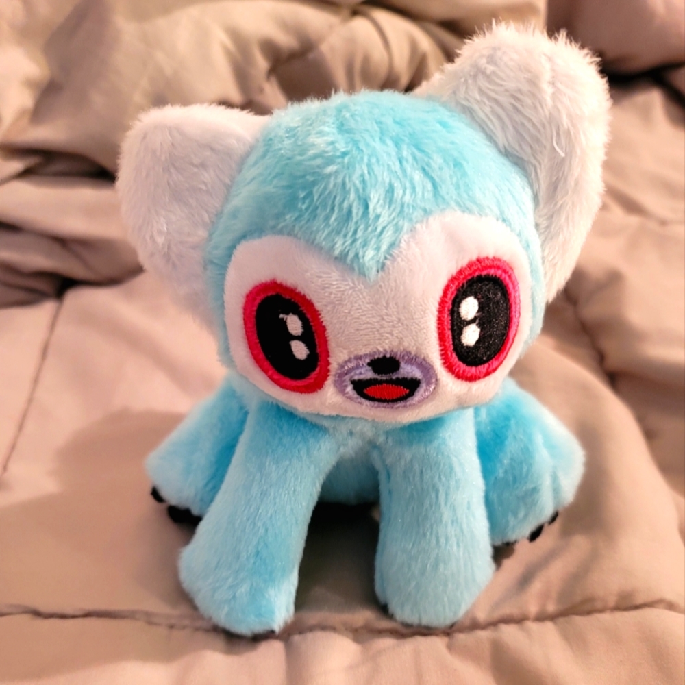 Barkbox dog toy animal with squeaky. Turquoise with black and white tail.